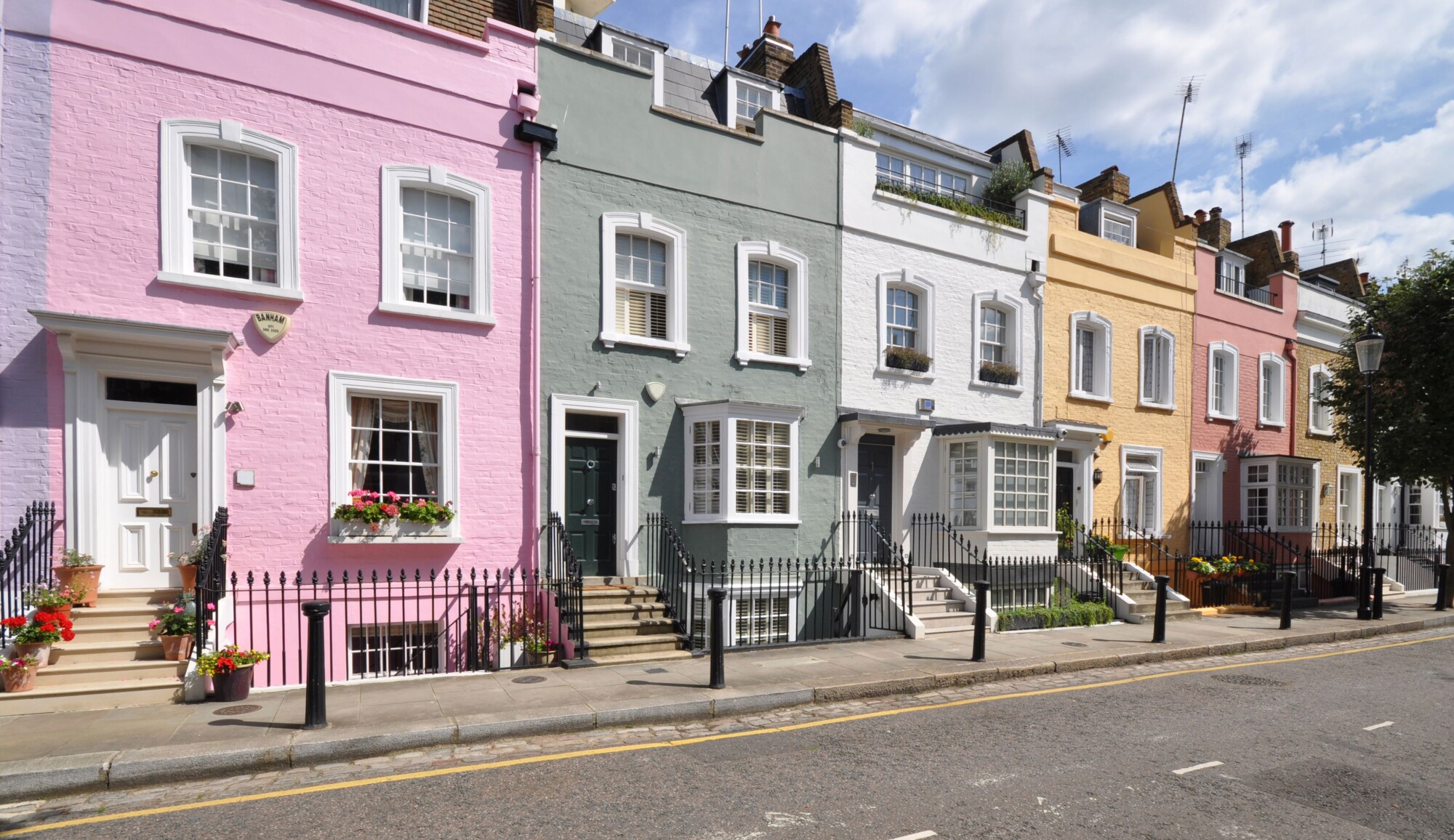 UK Budget for expats and overseas investors: this image shows a picture-perfect London street of colourful terraced houses